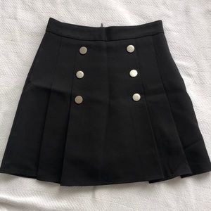 Black pleated skirt with silver buttons